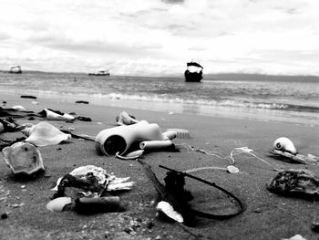 Close-up of abandoned beach against sky