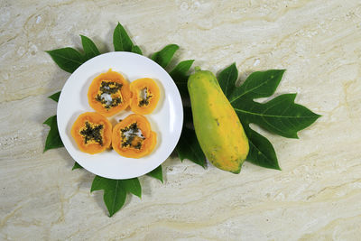 High angle view of fruits in plate on table