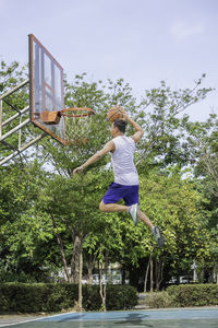 Man playing basketball on court