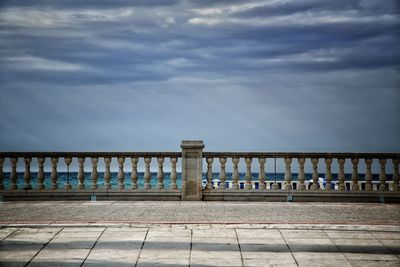 Row of railing against sky