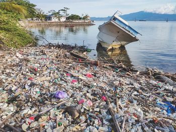 Garbage in river against built structures