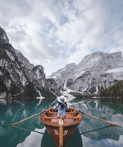 Scenic view of lake by snowcapped mountains against sky