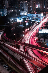 High angle view of light trails on bridge in city street