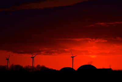 Silhouette of wind turbines at sunset