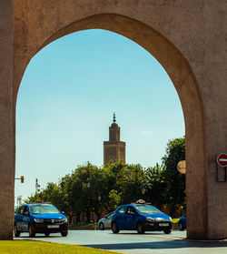 Cars on street amidst buildings against clear sky