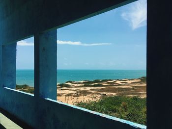 Scenic view of sea against sky seen through window