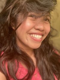 Close-up portrait of a smiling young woman