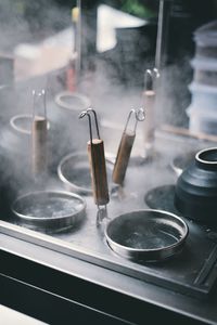 Close-up of cooking utensils amidst steam