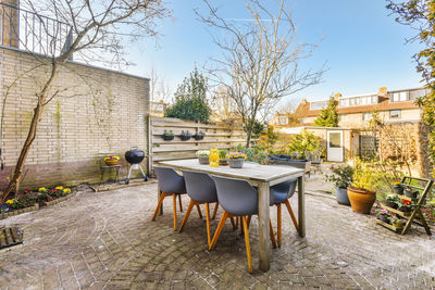 Empty chairs and tables in yard