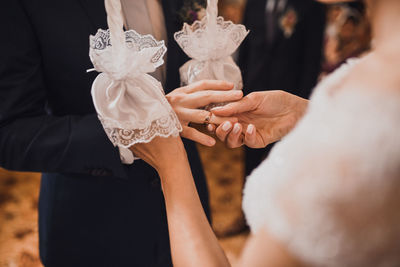 Midsection of woman holding wedding dress