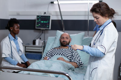 Female doctor examining patient in clinic