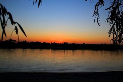 Scenic view of lake at sunset