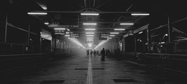 Rear view of man walking in tunnel