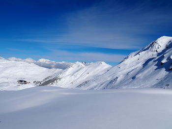 Scenic view of snow covered mountains against sky