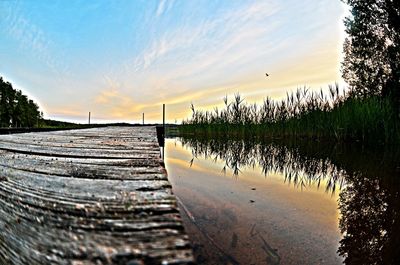 Wooden pier on sea against sky