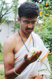 Young man wearing sunglasses while sitting outdoors