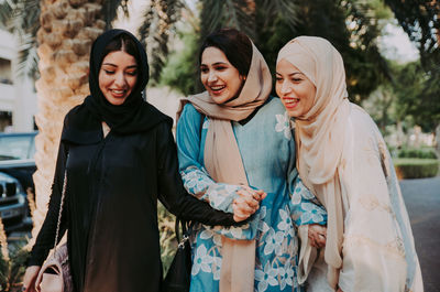 Portrait of smiling young women standing outdoors