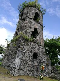 Low angle view of old ruin against sky