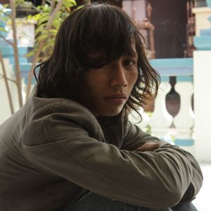 Close-up portrait of young man against railing