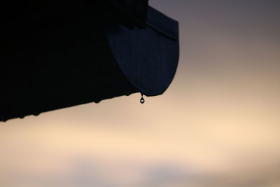 Low angle view of water drop against sky