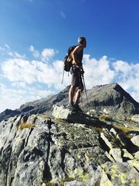 Low angle view of man standing on rock