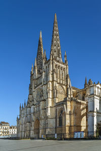 Low angle view of historical building against blue sky