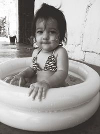 Portrait of cute baby boy in water