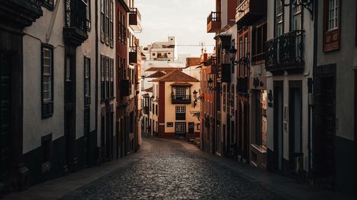 Narrow street amidst buildings in city