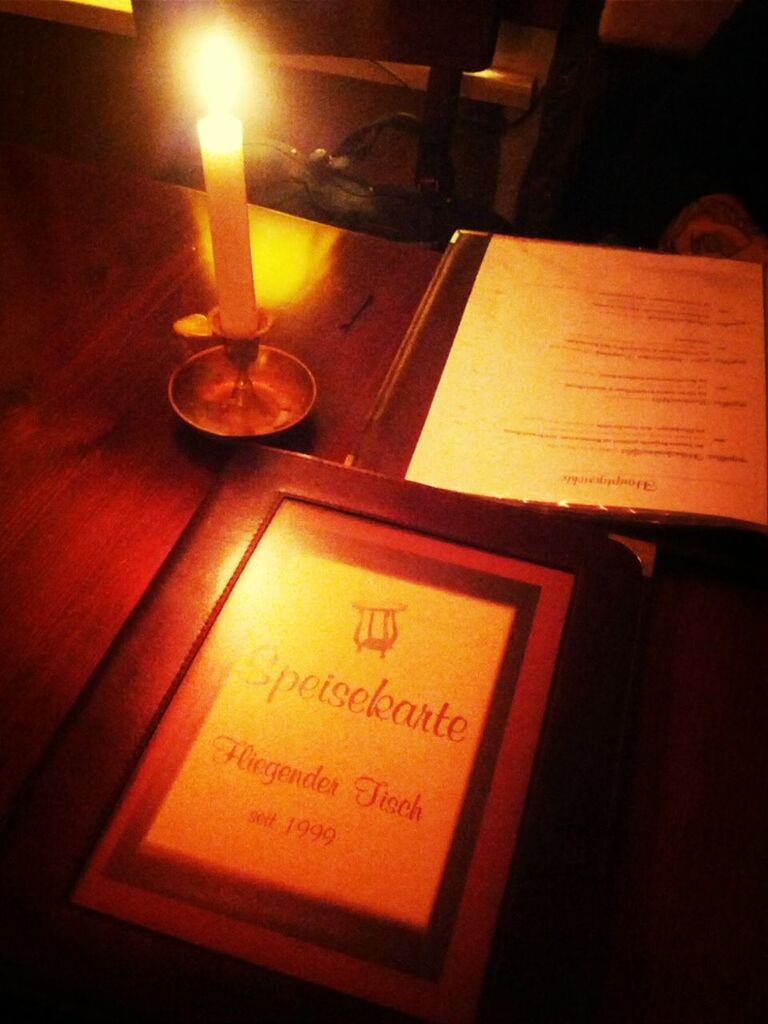 text, indoors, communication, western script, illuminated, close-up, lighting equipment, table, paper, still life, glowing, number, candle, electricity, non-western script, no people, light - natural phenomenon, night, lit, information
