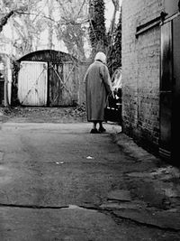 Full length of woman walking on footpath