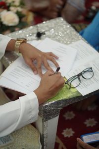 High angle view of woman holding paper with text