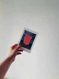 Person holding umbrella against white background
