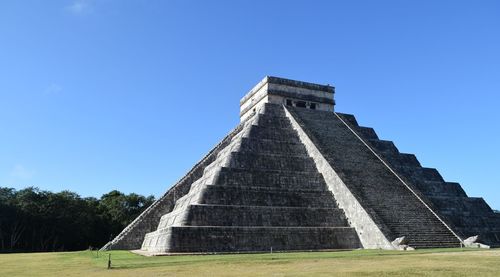 Low angle view of historical building against blue sky