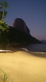 Scenic view of beach against sky at night