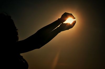 Close-up of hands pretending to hold sun