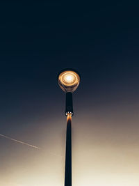 Low angle view of illuminated street light against sky