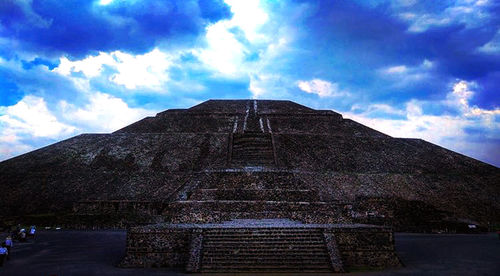 Low angle view of historical building against cloudy sky