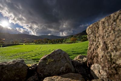 Scenic view of landscape against dramatic sky