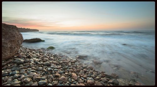 Scenic view of sea at sunset