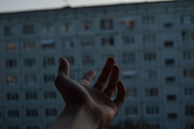 Close-up of person hand on window