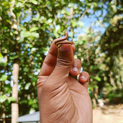 Cropped hand of woman holding ring