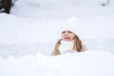 Portrait of a smiling girl in snow