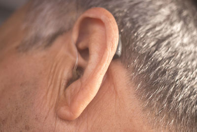 Close-up of man with hearing aid