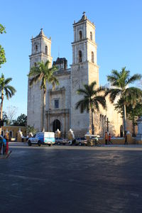 People in front of building against clear sky