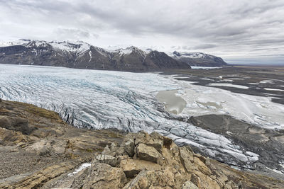 Scenic view of mountains and glacier against sky