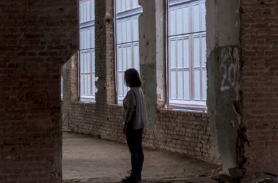 Full length of man standing on window