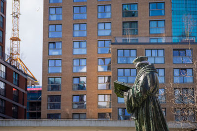 Climate activists blindfold desiderius erasmus statue 