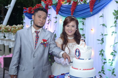 Portrait of happy young woman holding bouquet