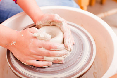 Hands working on pottery wheel