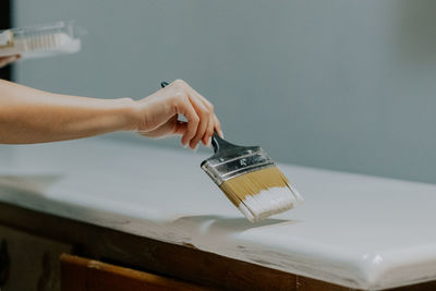 A young girl is painting an old closet.